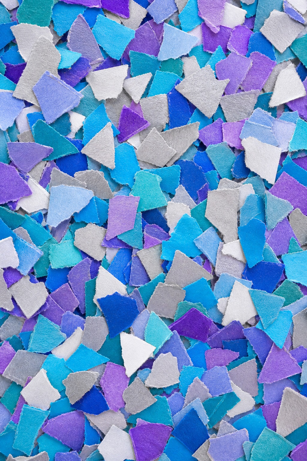 Colorful irregular paper chips scattered across a textured confetti background