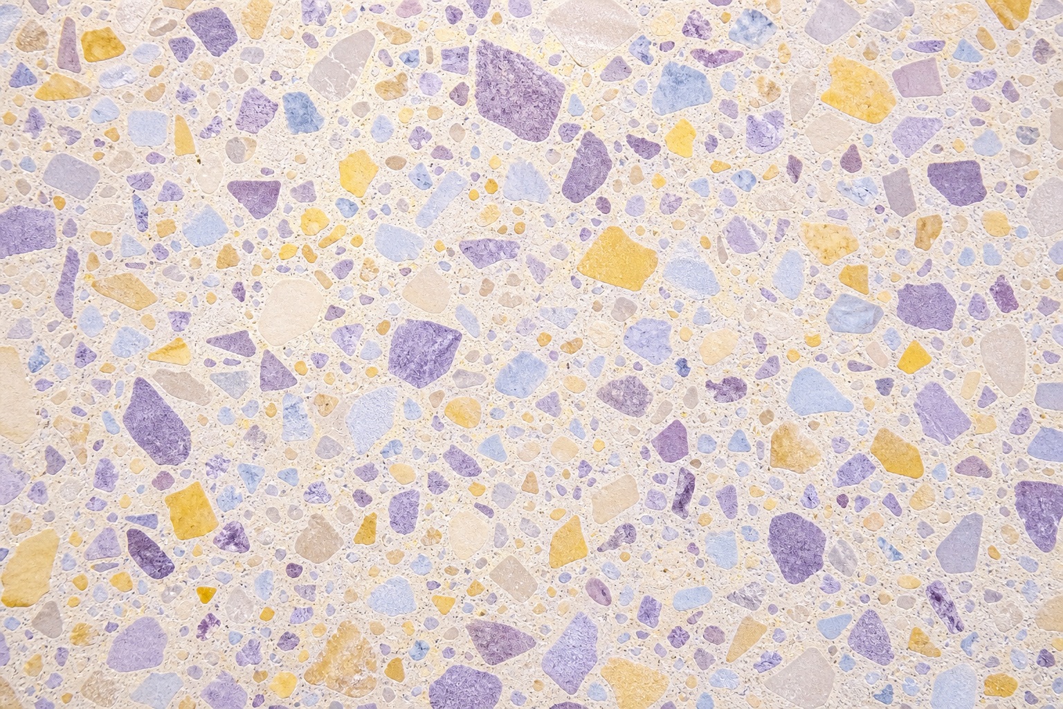 Lavender and yellow terrazzo pattern with mixed colorful chips on a light background