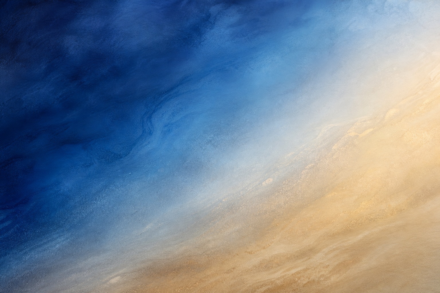Abstract gradient background fading from deep indigo blue to warm sandy beige.