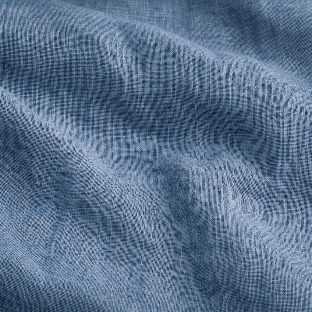 Blue linen fabric texture with soft woven folds and subtle wrinkles