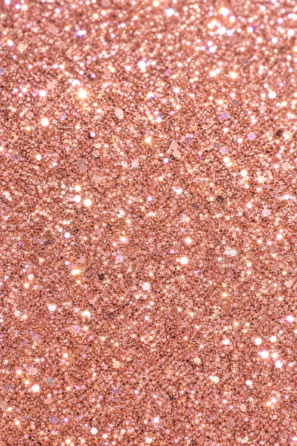 Vertical rose gold glitter texture with sparkling light flecks throughout