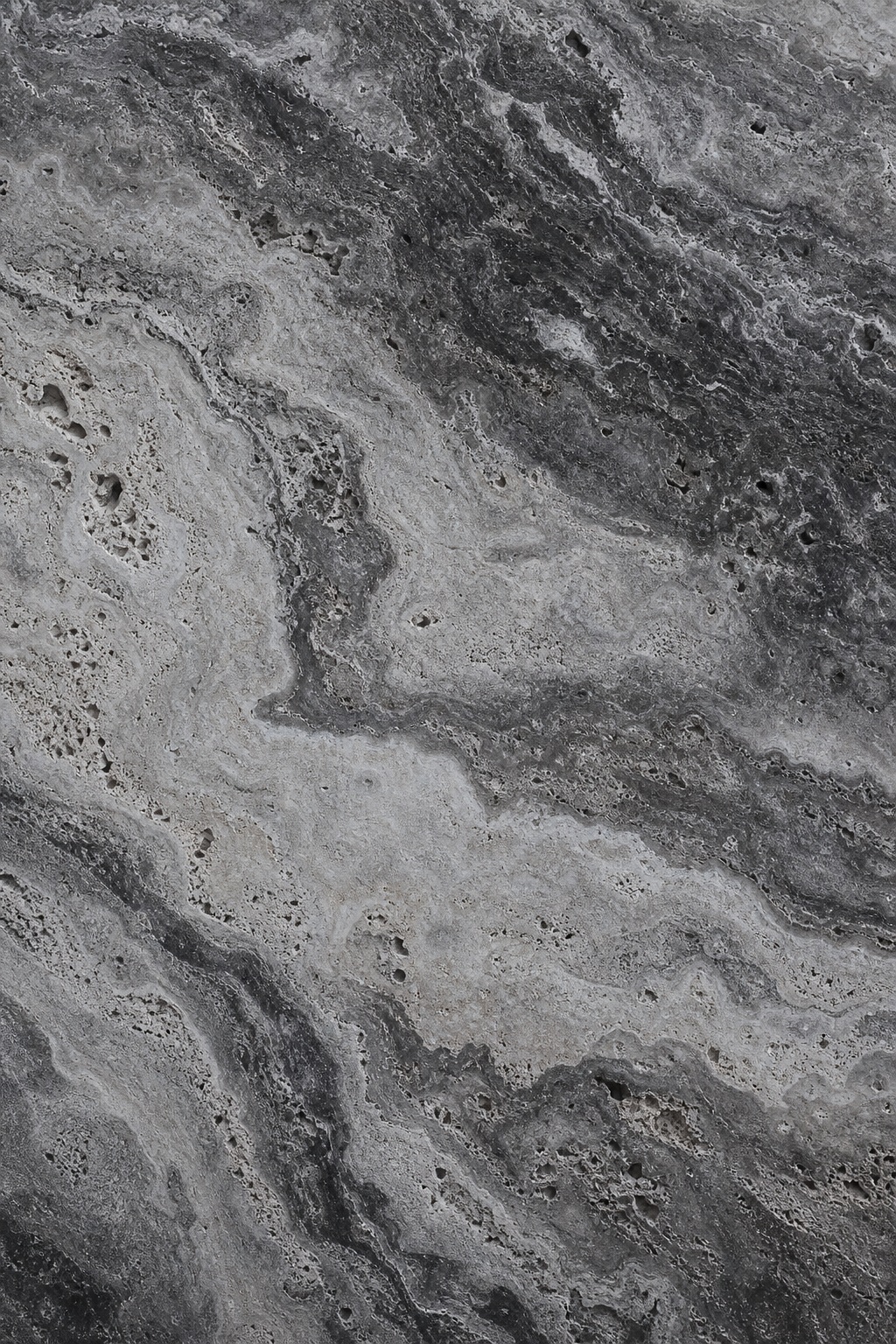 Smoky charcoal and pale gray travertine stone texture with flowing mineral bands.