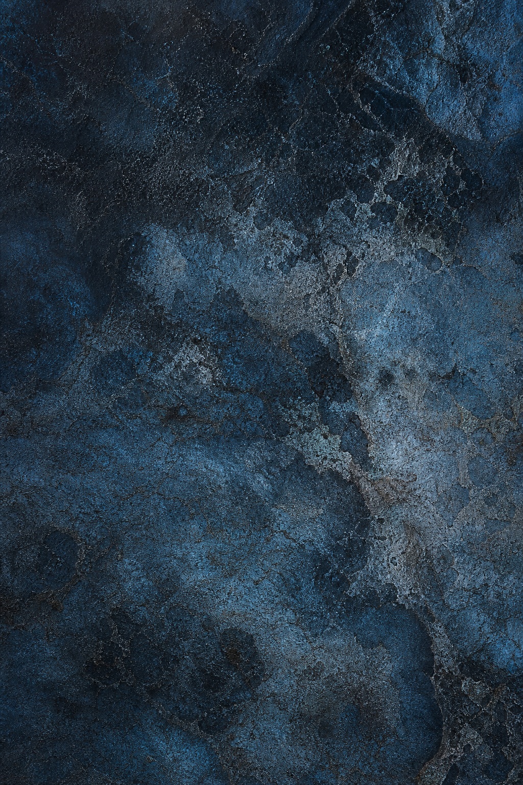 Dark blue and black weathered texture with oxidized patina patterns