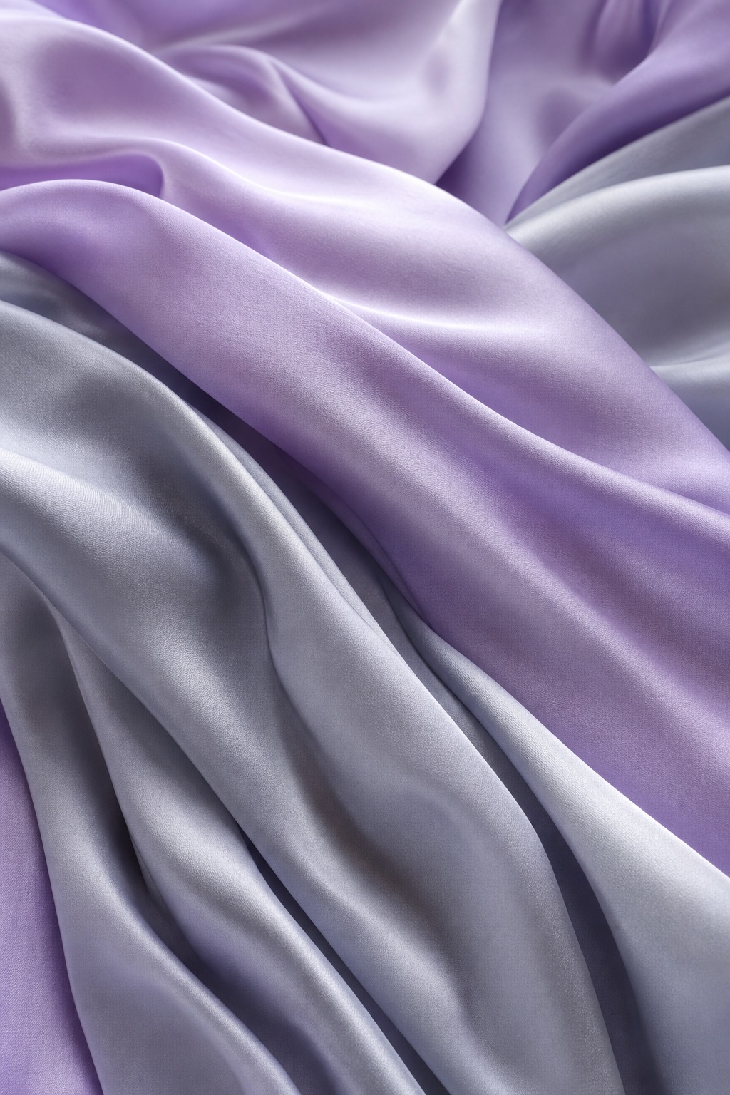 Lilac and silver silk-like fabric folds with a soft draped texture