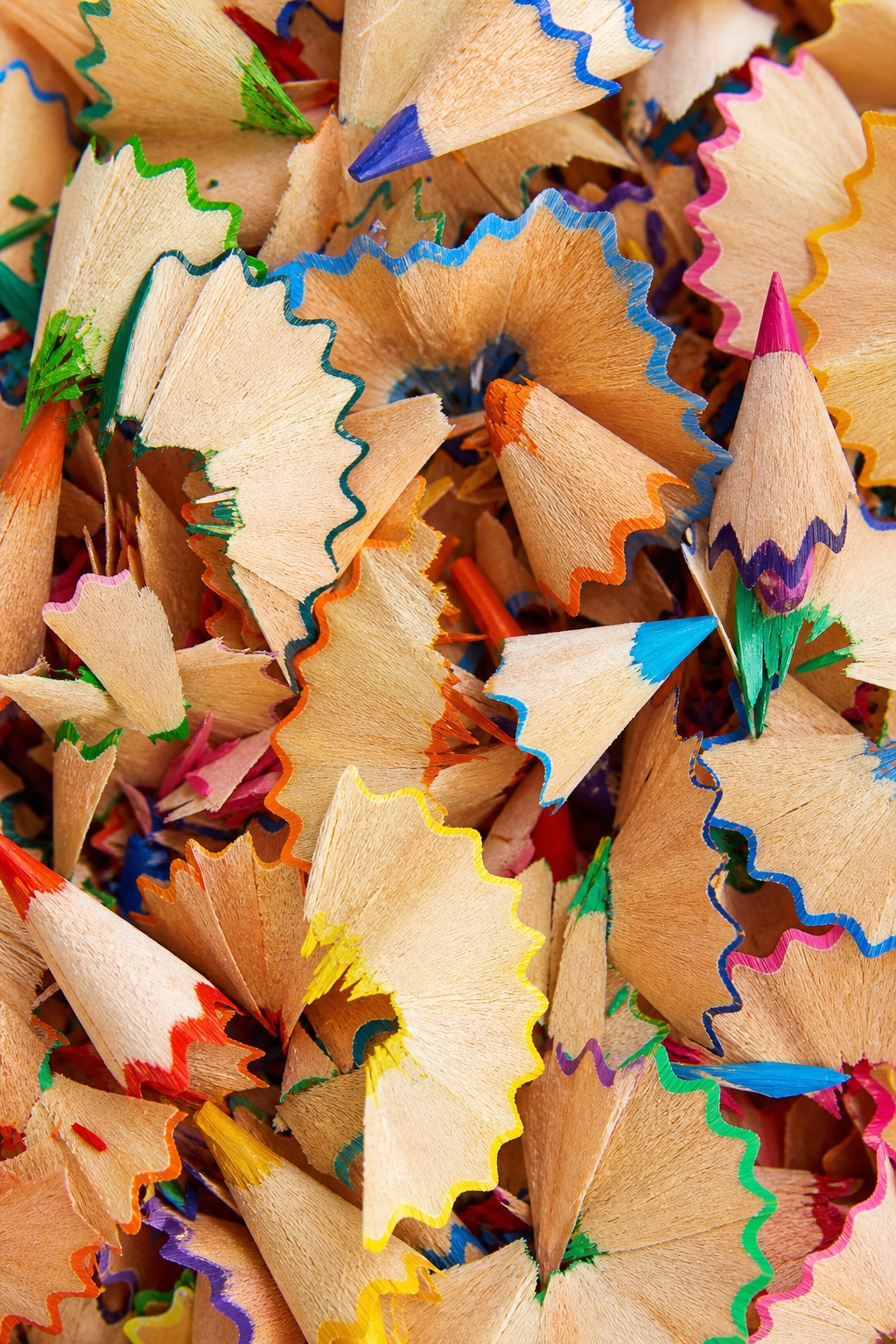 Close-up of colorful vertical pencil shavings layered together.