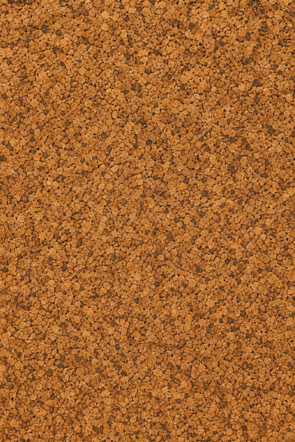 Brown cork granules forming a dense textured surface background.