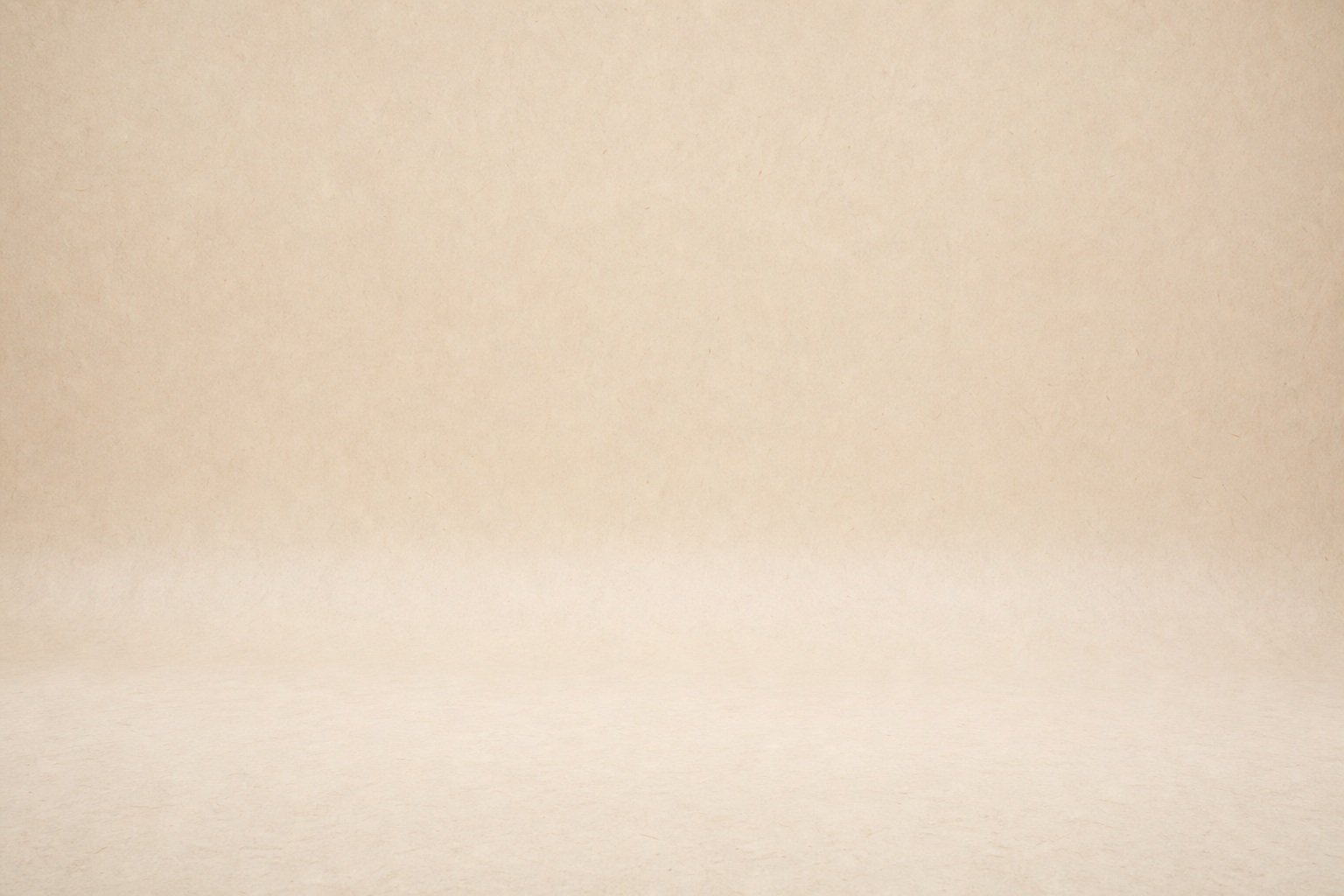 Warm beige paper backdrop with a soft shadow and clean studio surface