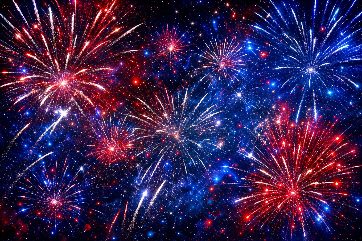 Red, white, and blue fireworks bursting over a dark night sky