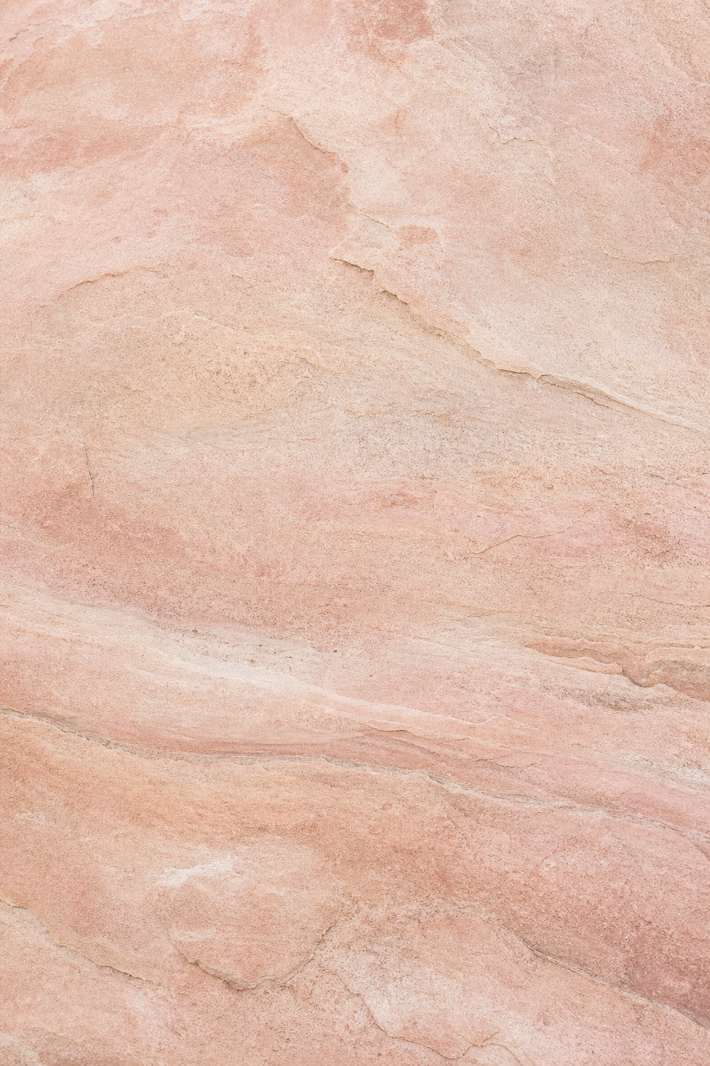 Warm blush sandstone texture with soft layered mineral veining