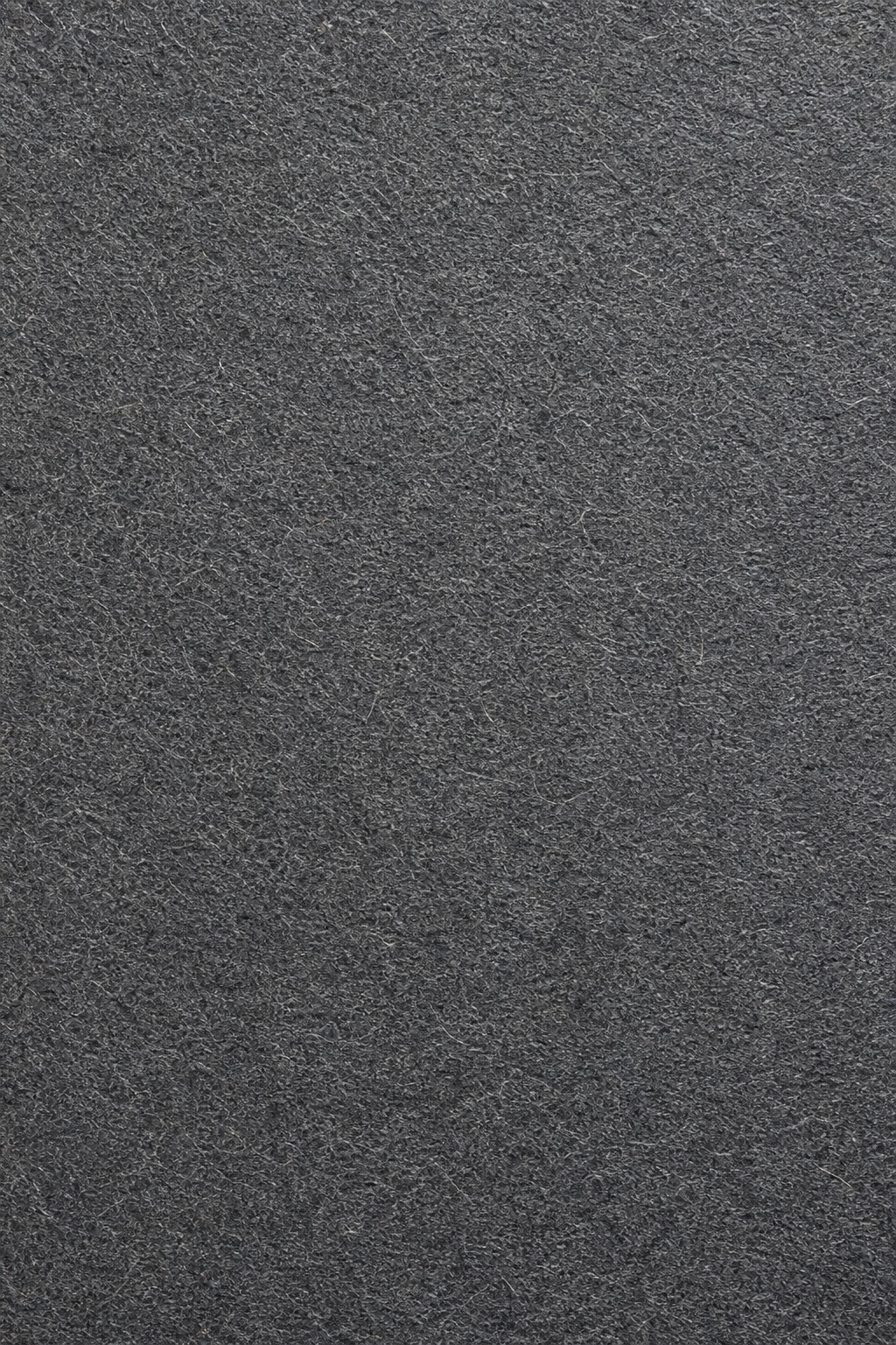 Dark charcoal paper texture with fine vellum grain and subtle natural fiber detail.