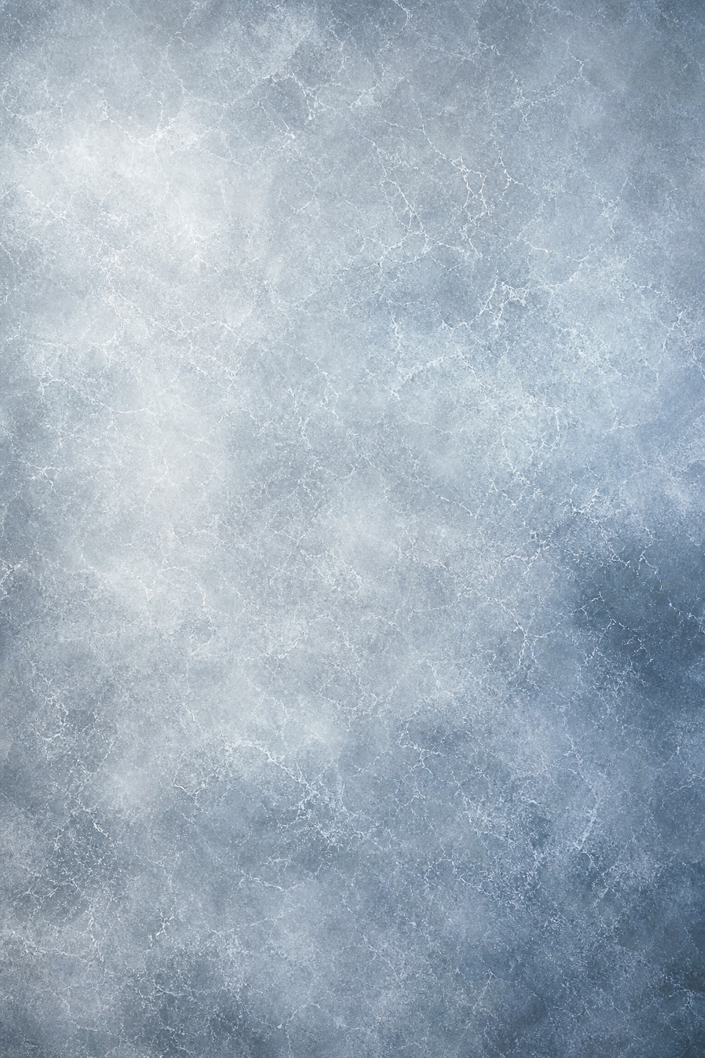 Frosted ice surface with pale blue-gray texture and subtle crackle patterns