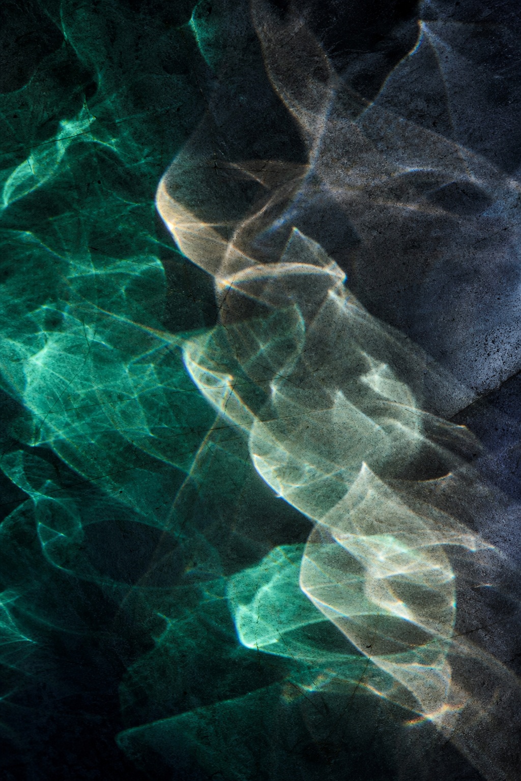 Abstract emerald and charcoal light reflections forming a prismatic spectral pattern