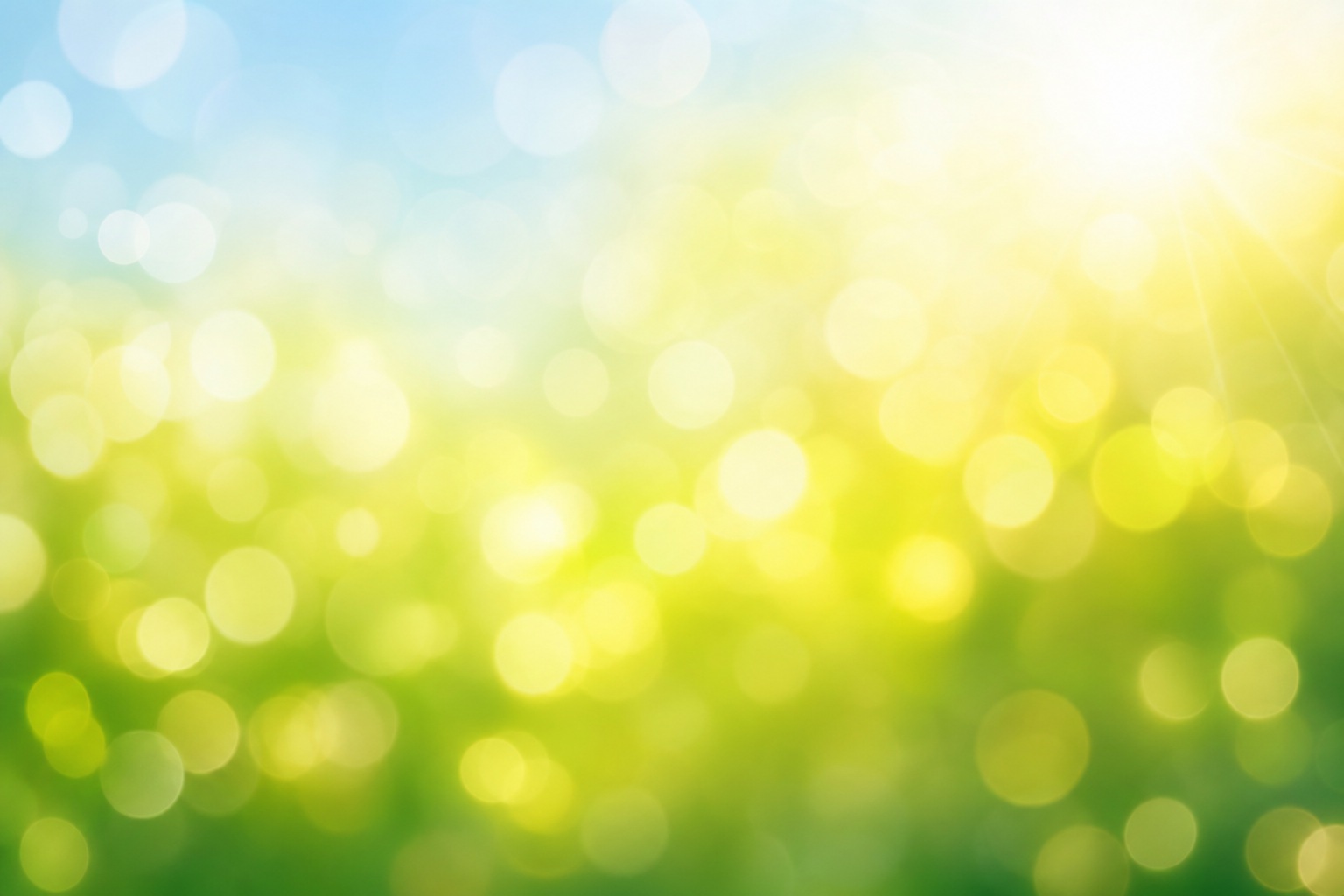 Soft green bokeh lights with a bright sunlit glow and blurred abstract background.