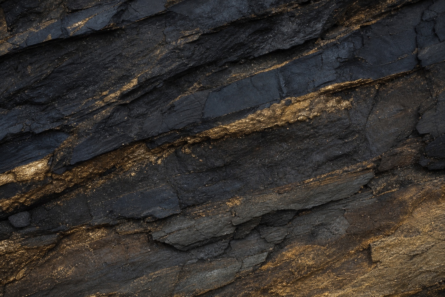 Dark layered stone texture with gold mineral seams across the surface