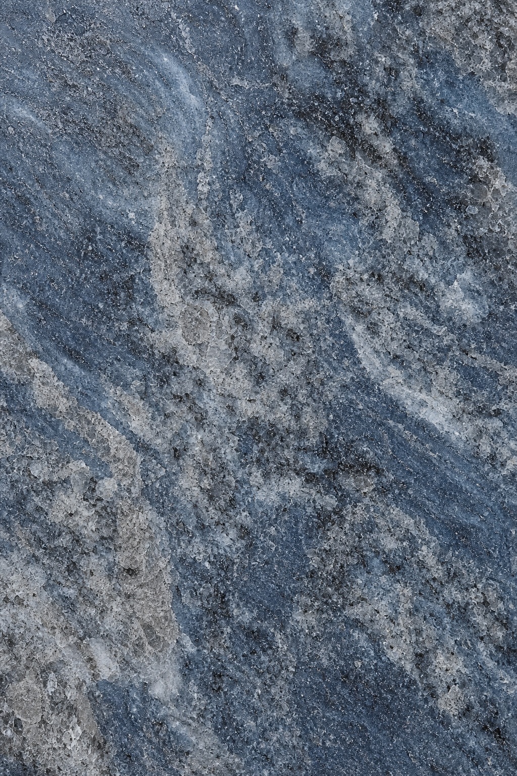 Blue gray polished granite surface with clouded mineral grain and flowing stone pattern