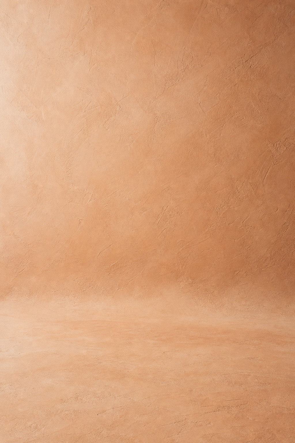 Vertical peach clay surface with a soft shadow and clean studio backdrop