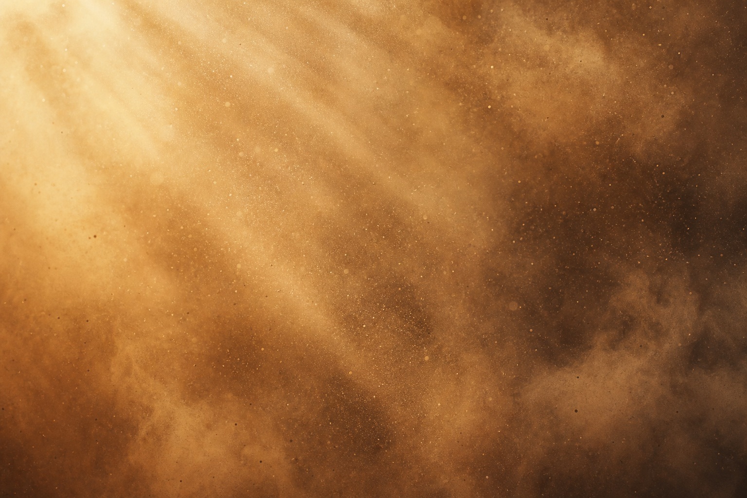 Warm golden light rays shining through drifting dust in a hazy background