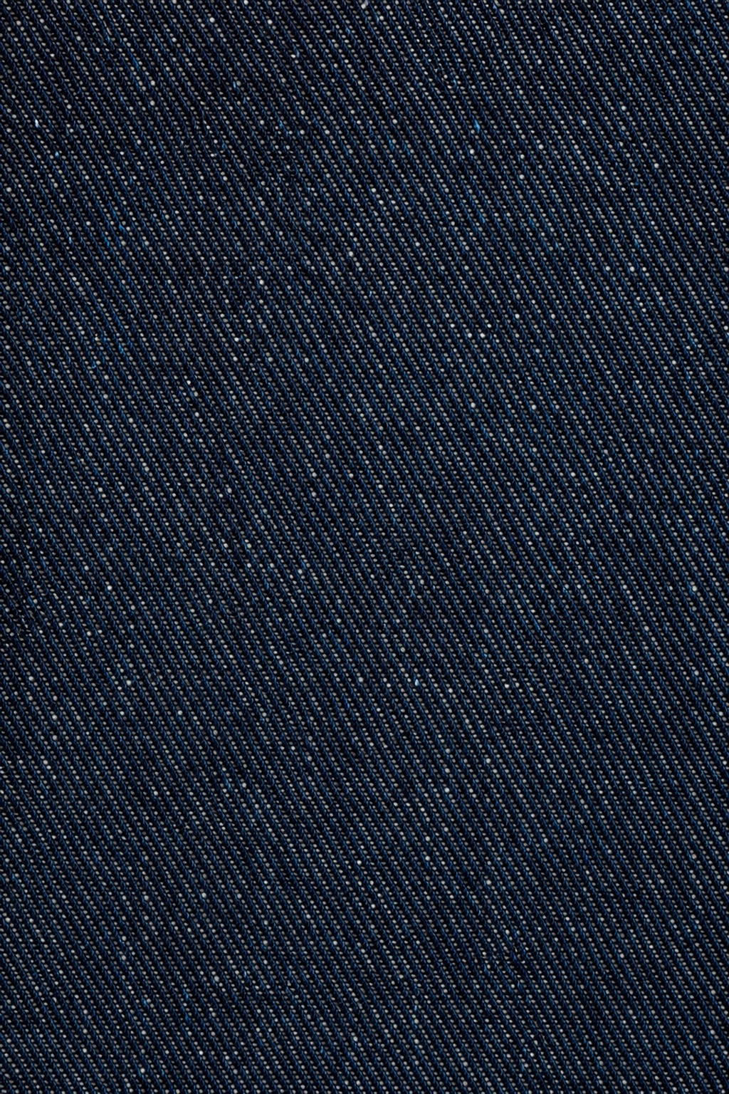 Dark indigo woven denim fabric texture with diagonal threads