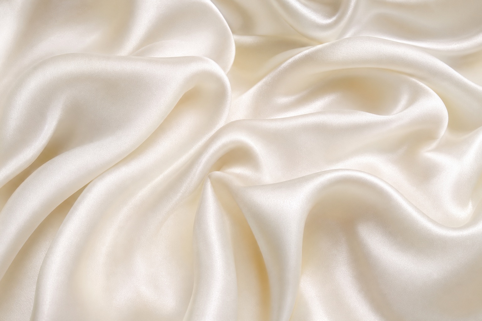 Soft ivory silk fabric folds with a smooth, glossy texture
