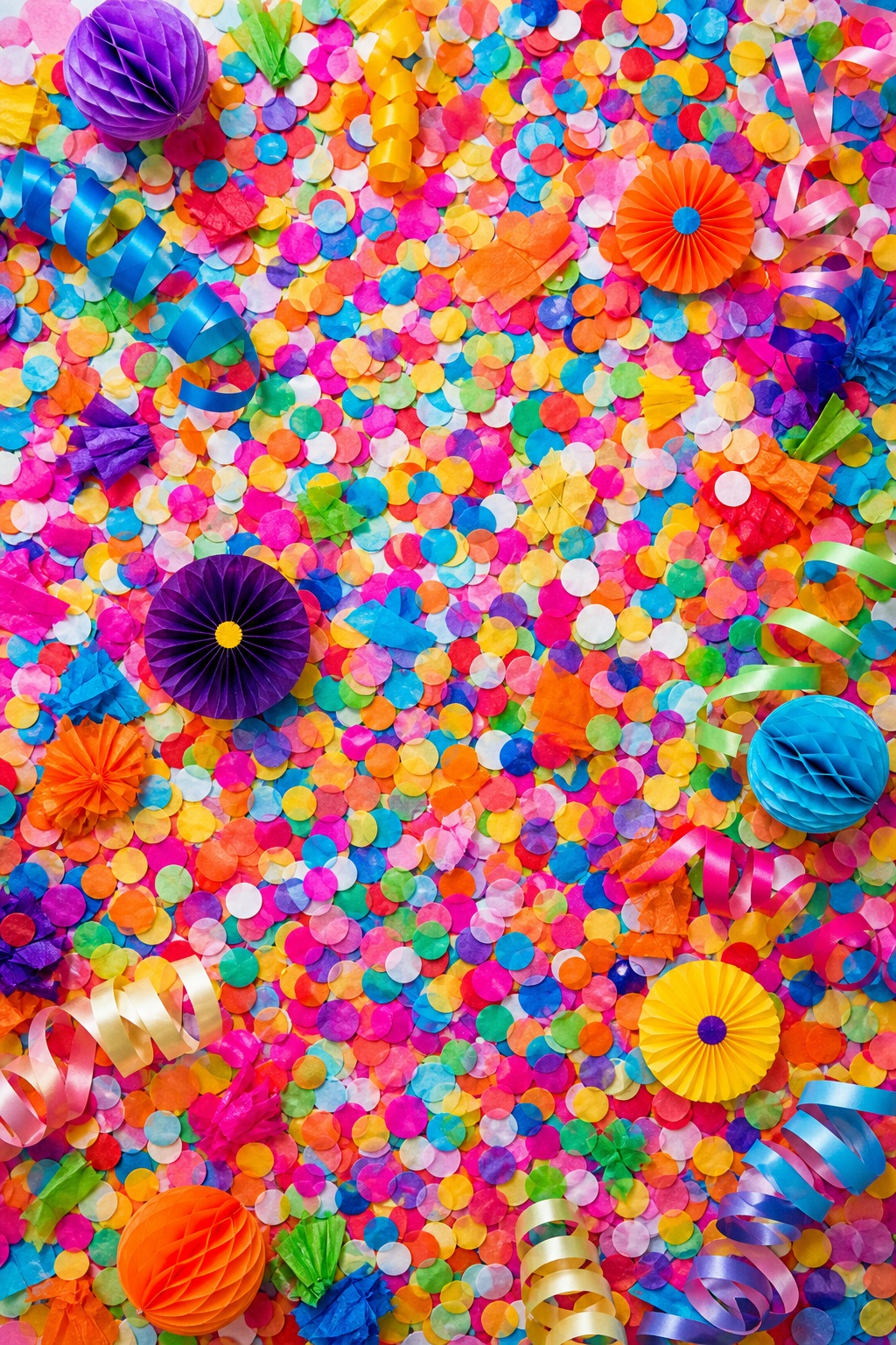 Colorful vertical confetti scatter with balloons and party streamers on a bright background