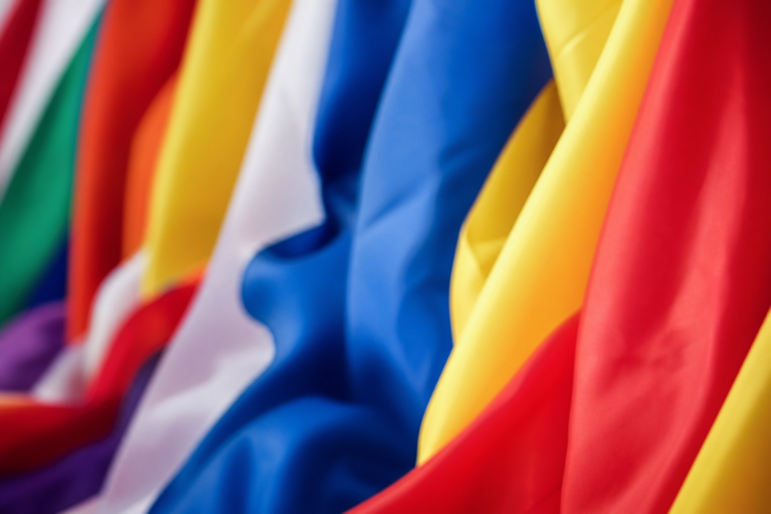 Colorful fabric flags with flowing red, yellow, blue, and white stripes