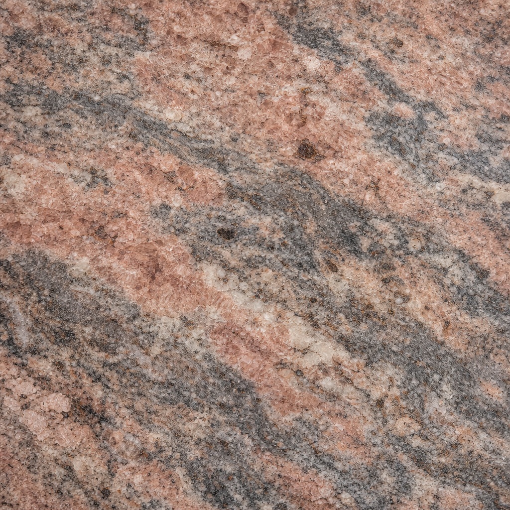 Polished rose granite surface with clouded mineral grain and stone pattern