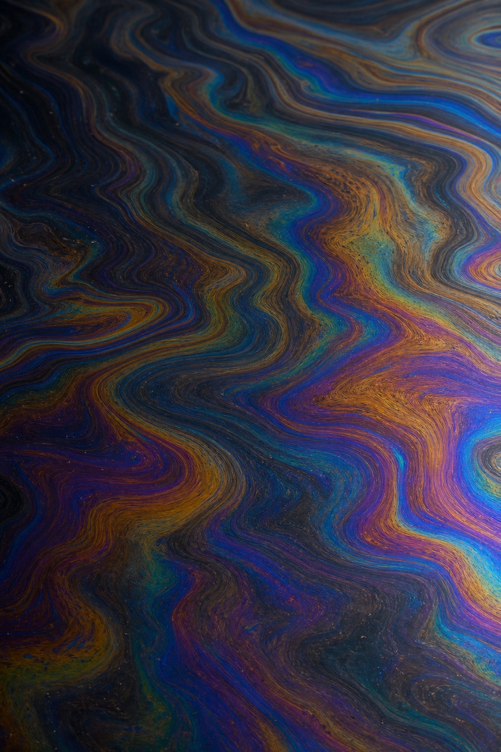 Dark iridescent texture with rainbow bands and concentric interference rings