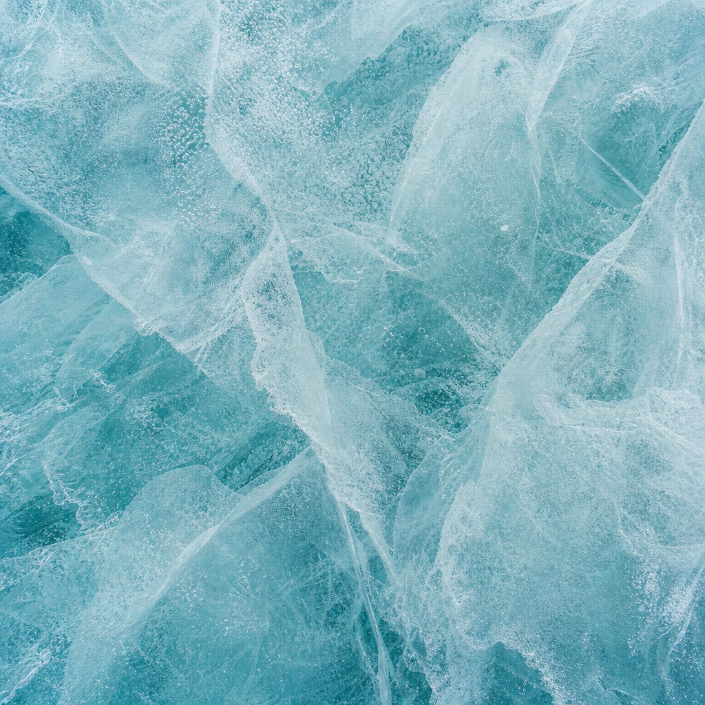 Aqua teal frosted ice texture with layered translucent frost patterns.