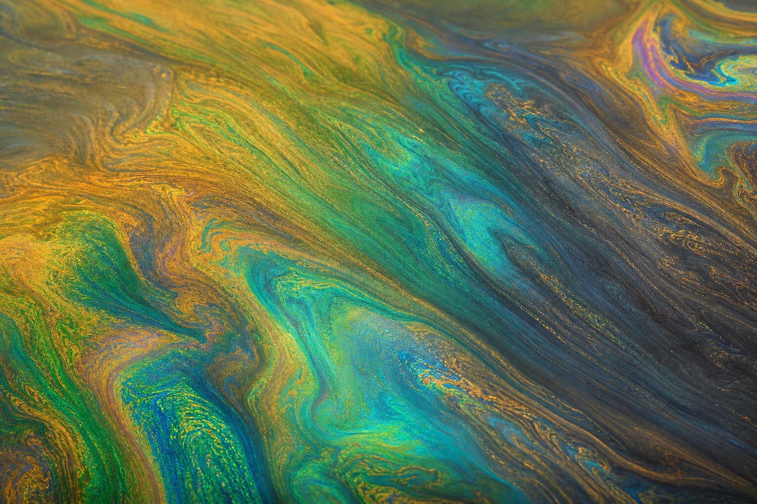 Abstract oil slick texture with gold, emerald, teal, and rainbow spectrum bands