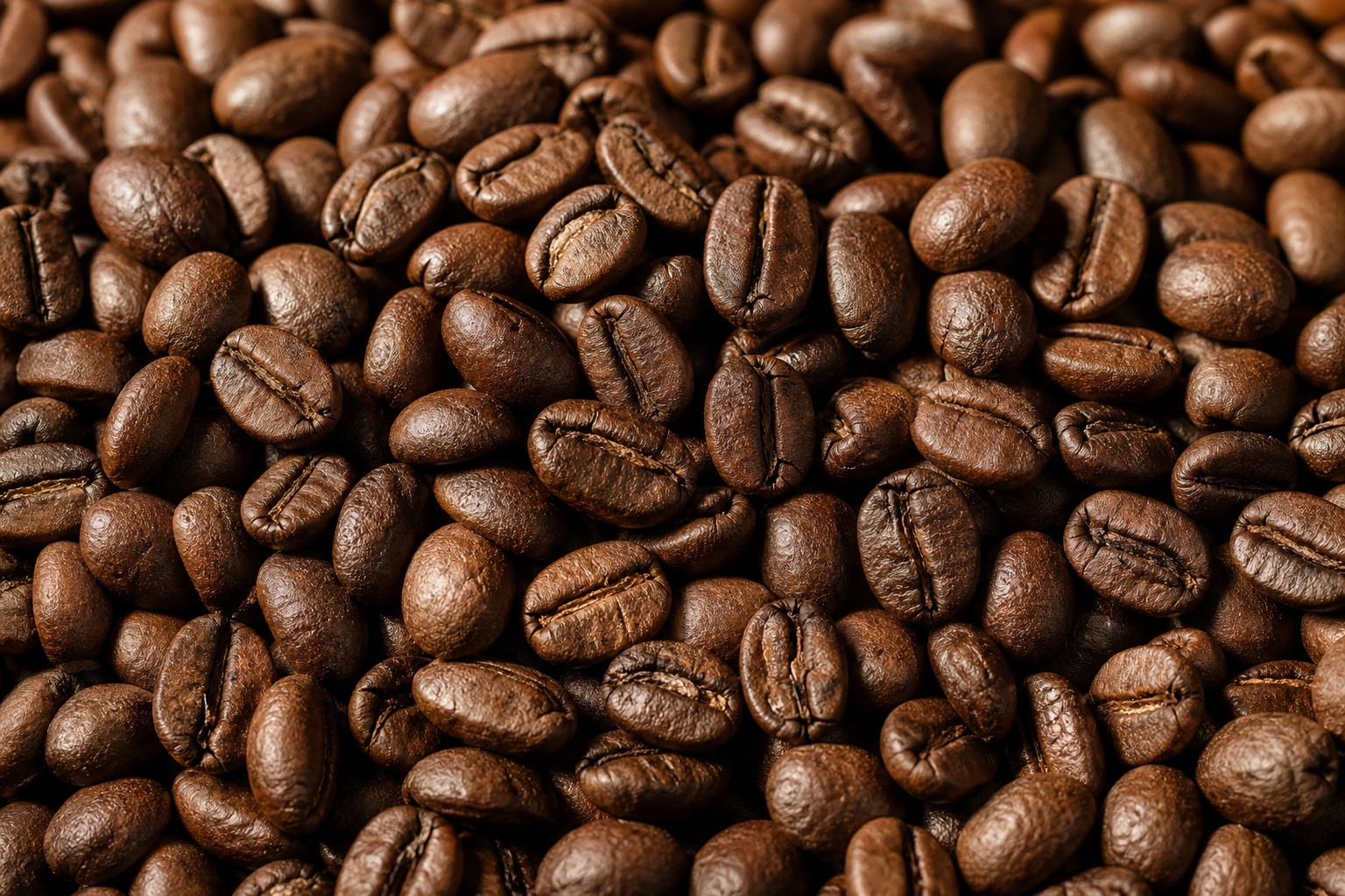 Close-up background of roasted coffee beans with rustic side lighting and textured surfaces