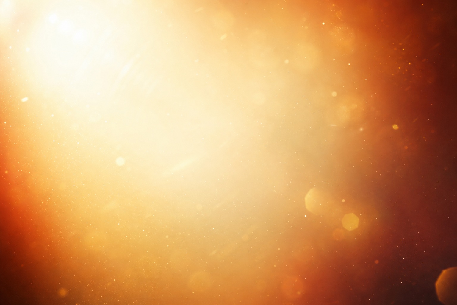 Warm golden bokeh lights and sunlit glow on a dark abstract background