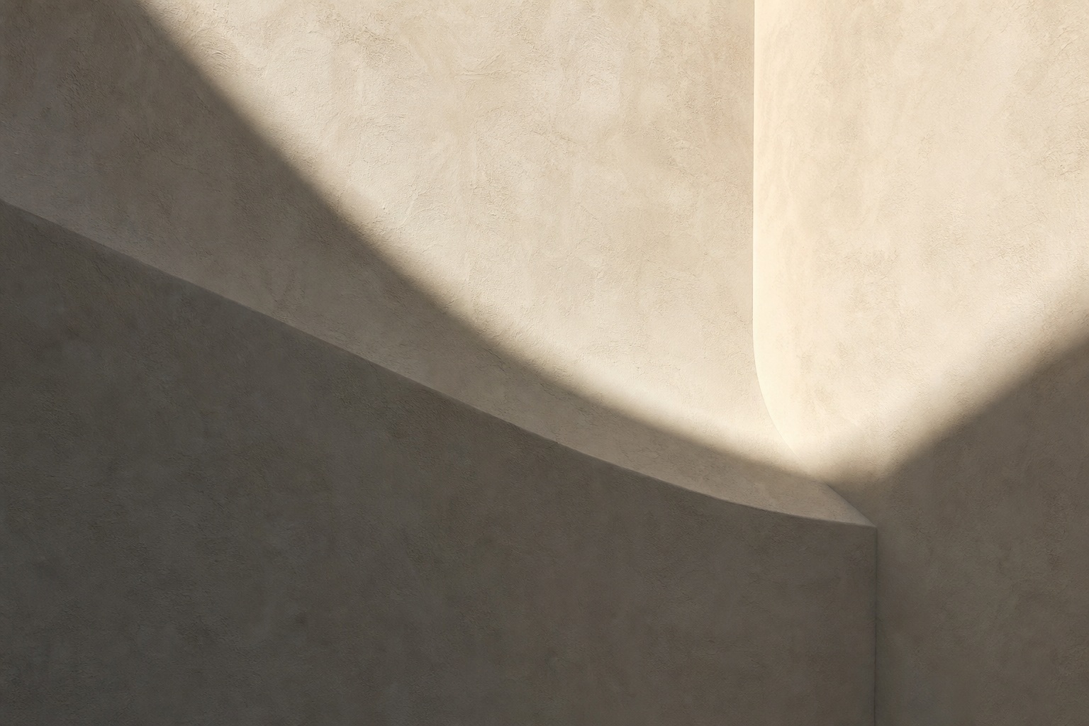 Abstract warm plaster wall with a hard diagonal shadow and curved light edge.