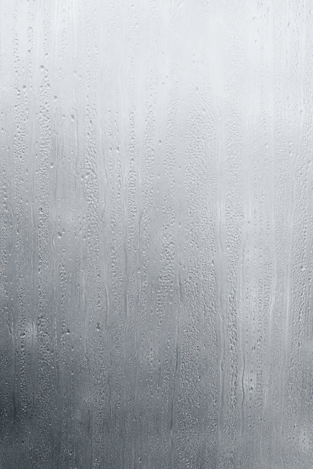 Vertical condensation streaks and droplets on a frosted glass surface