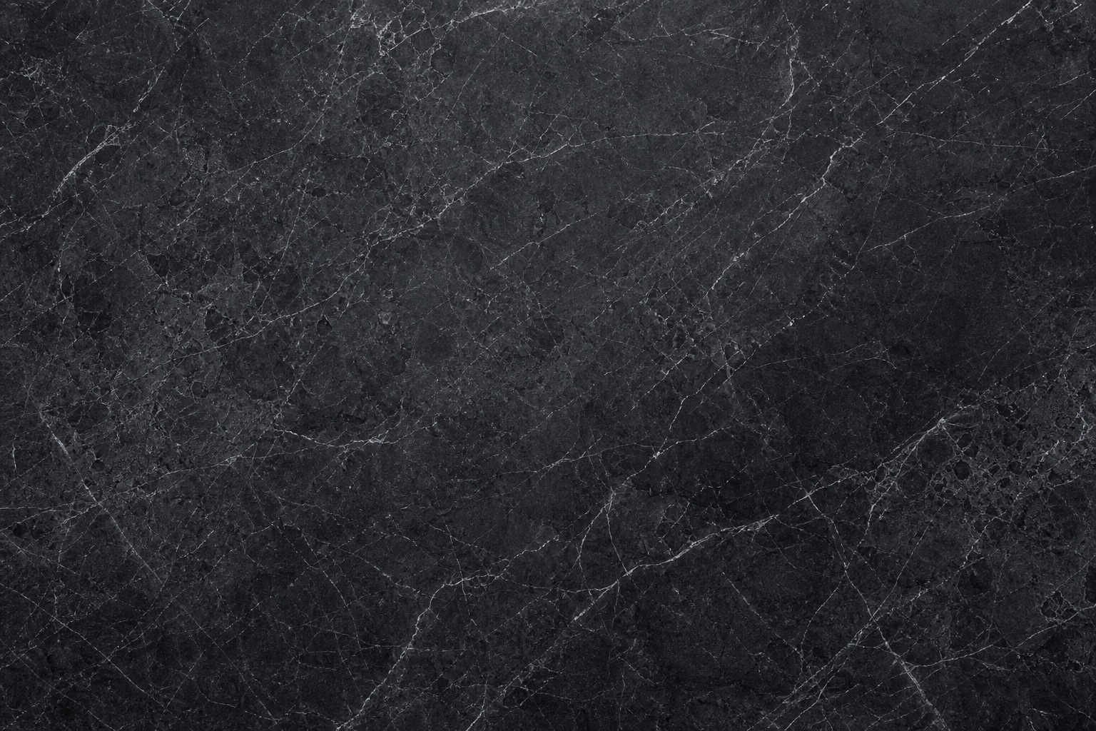 Dark charcoal marble surface with fine white veining and subtle stone texture