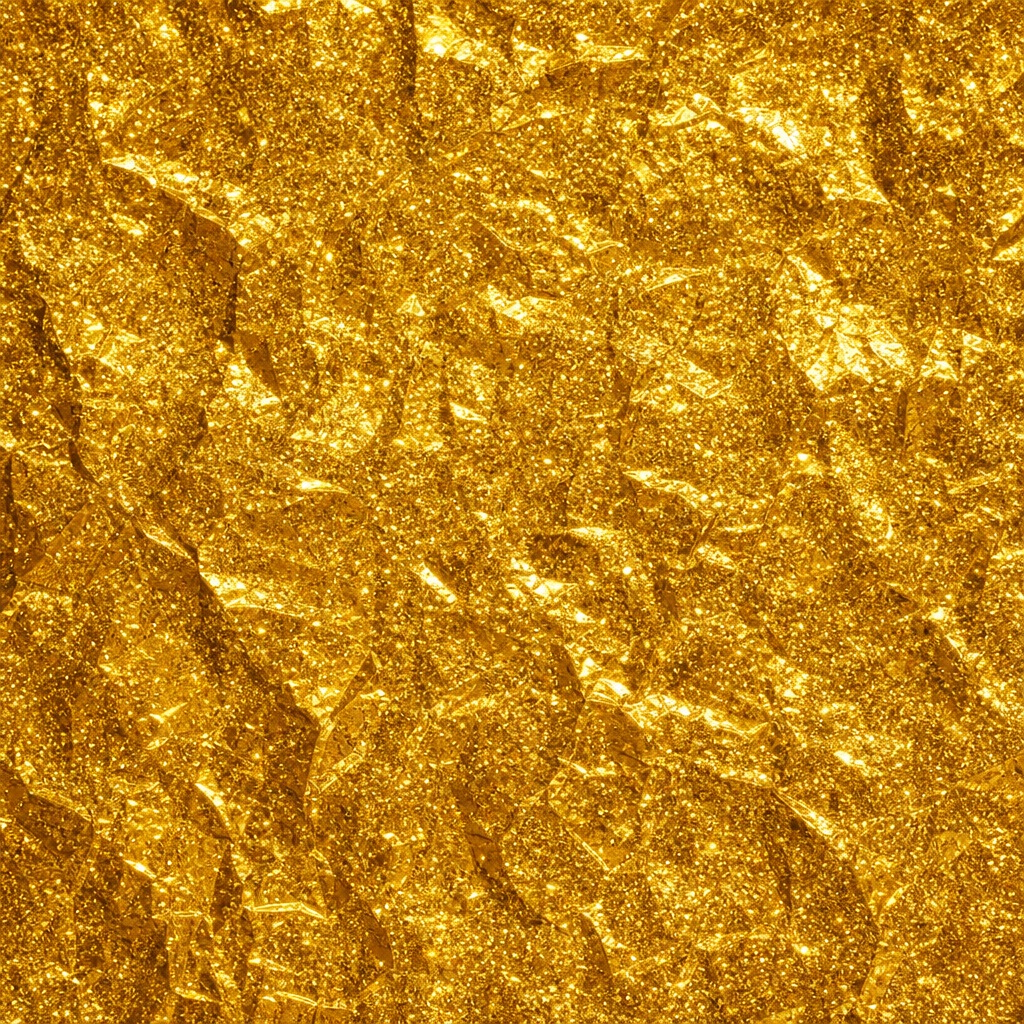 Gold glitter foil texture with crumpled reflective sparkle pattern