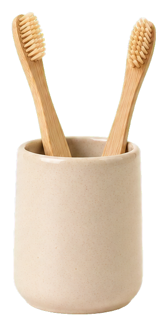 A beige toothbrush cup holding two wooden toothbrushes.