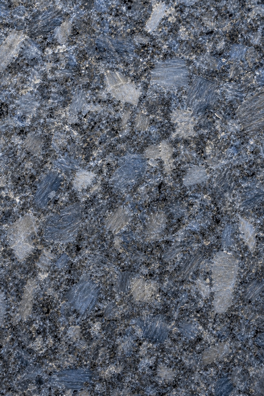 Blue gray polished granite surface with mixed crystalline stone pattern and mineral grain