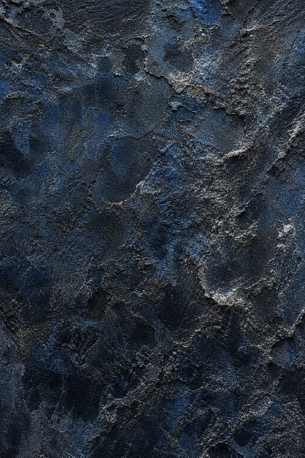 Dark blue-black eroded stone texture with rough weathered surface details