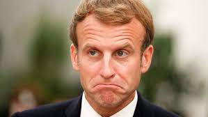 Close-up portrait of Emmanuel Macron with a neutral expression.