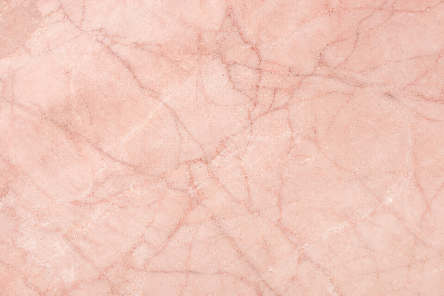 Soft rose marble surface with delicate natural veining and a smooth stone texture.