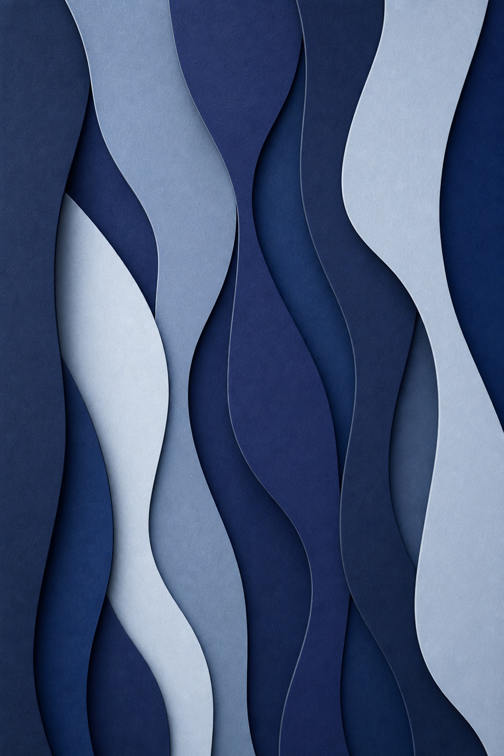 Layered indigo and blue abstract paper shapes with soft shadows and depth.