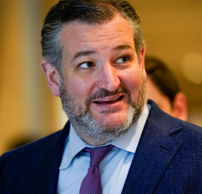 Close-up of a bearded man in a suit and tie looking to the side.