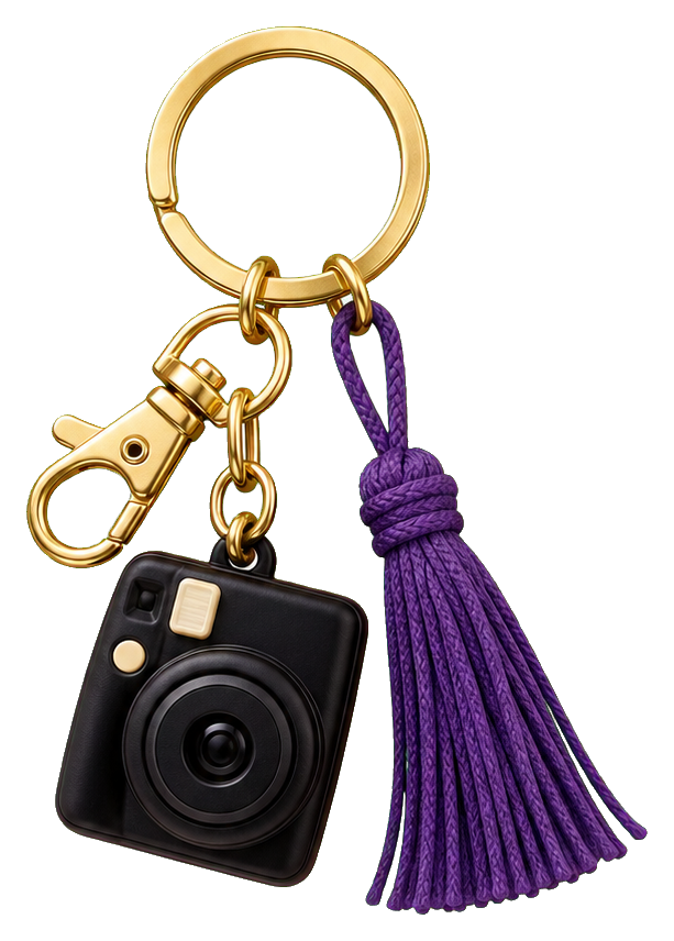 Camera charm sticker with a gold ring, black camera pendant, and purple tassel