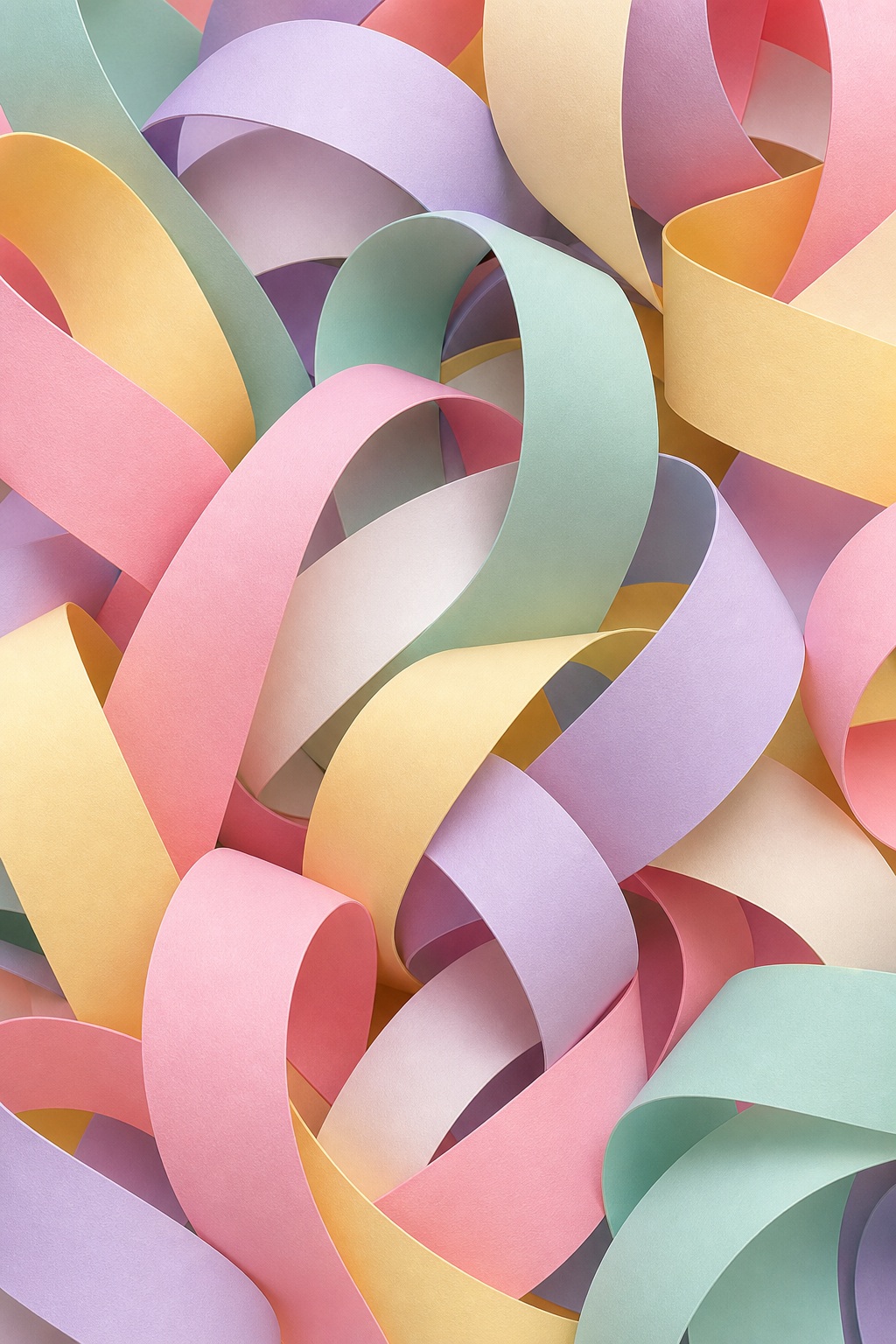 Pastel paper ribbon loops in pink, mint, yellow, lavender, and peach overlapping in an abstract pattern