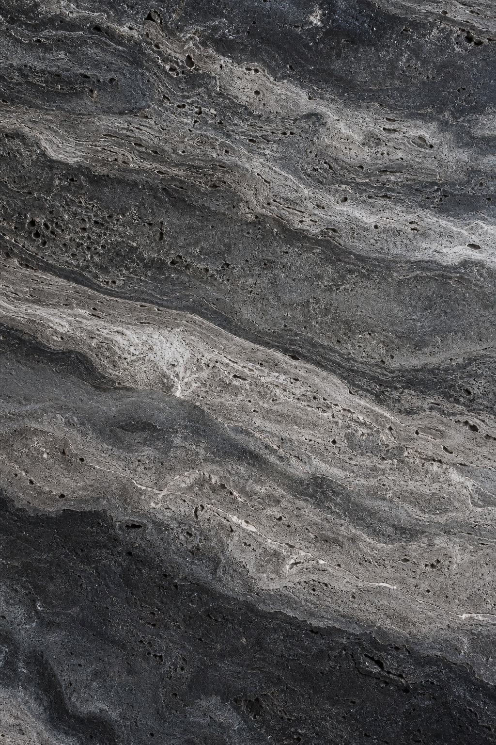Dark smoky charcoal stone texture with layered travertine-like mineral bands