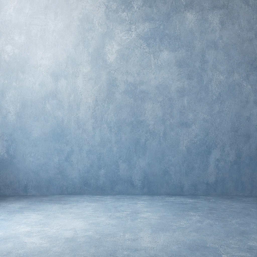 Square dusty blue studio backdrop with a soft textured floor and wall