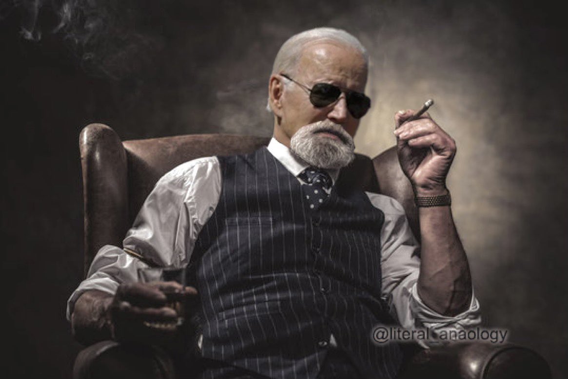 Older gentleman in sunglasses and suit holding a cigar in a moody portrait scene.