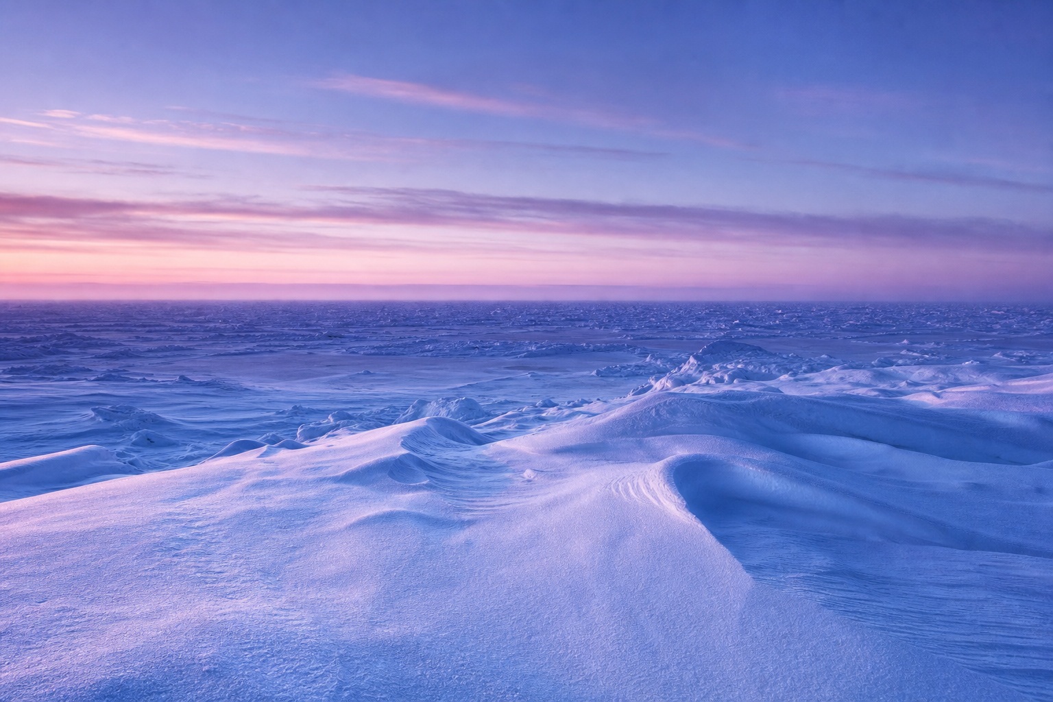 Snowy arctic landscape under a purple and pink twilight sky