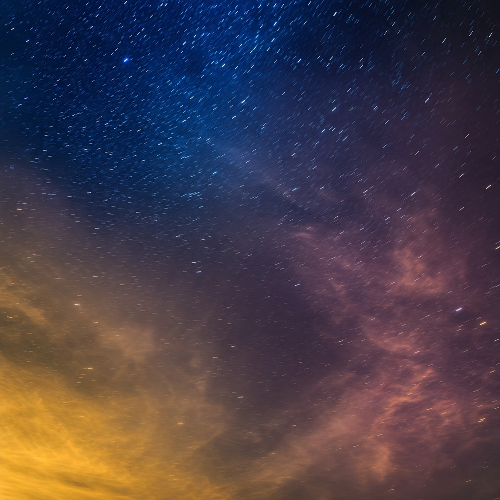 Gold and indigo night sky with scattered stars and subtle long exposure streaks