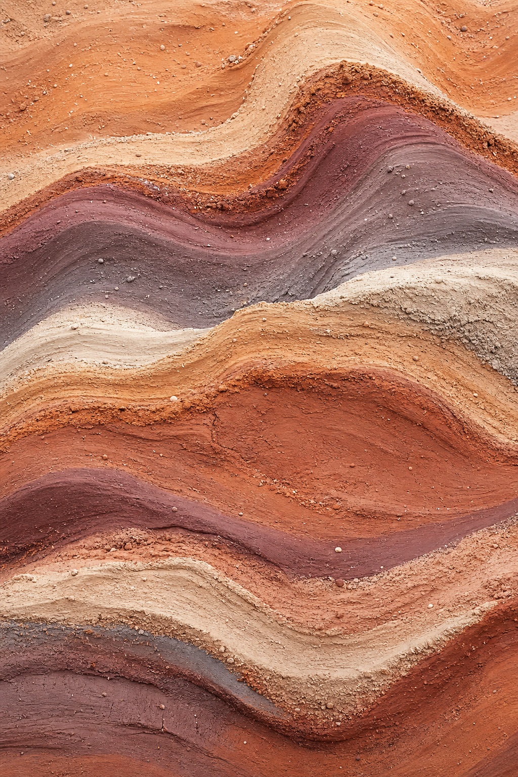 Warm layered mineral and clay textures forming flowing abstract bands.